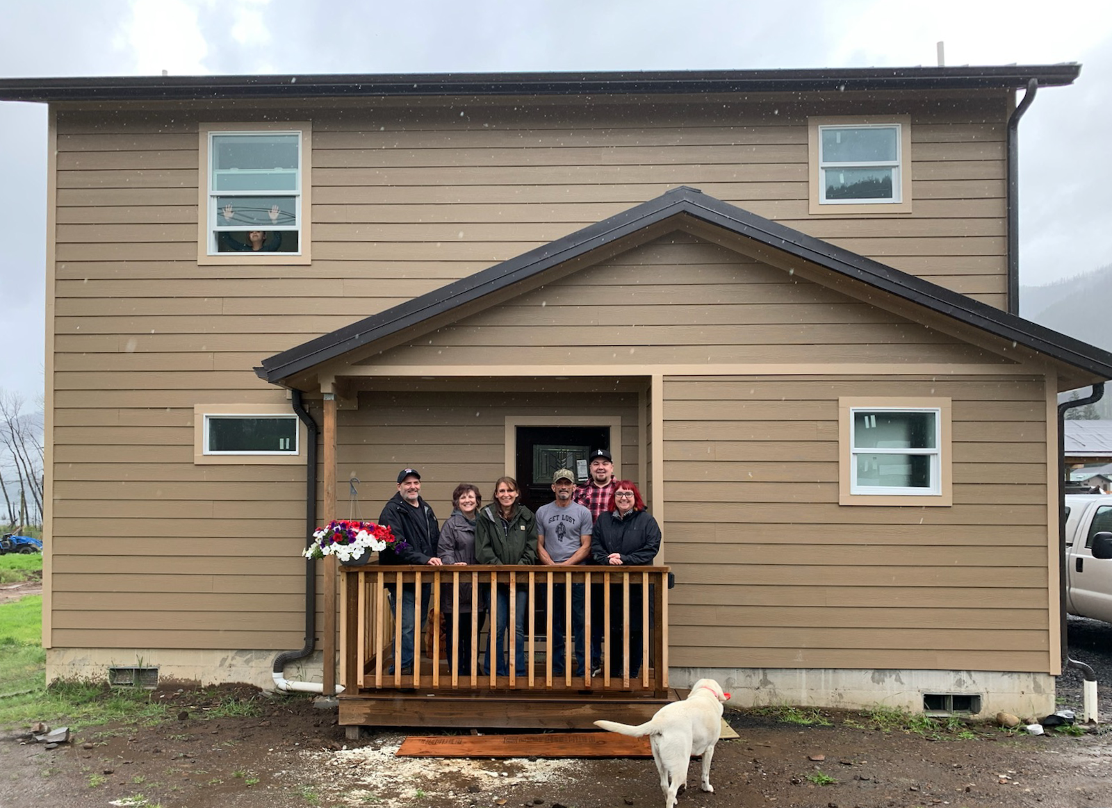 NW Rebuild Project team with the Warden family in front of their completed home — Detroit, Oregon